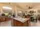 Well-appointed eat-in kitchen with stainless appliances, center island, and views of the dining area and backyard at 6031 N Milano Ct, Litchfield Park, AZ 85340