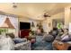 Comfortable living room featuring plush seating, a large TV, and lots of natural light at 6031 N Milano Ct, Litchfield Park, AZ 85340
