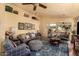 Spacious living room with plush sofas, ceiling fan, and stylish decor at 6031 N Milano Ct, Litchfield Park, AZ 85340