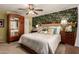 Comfortable bedroom showcasing patterned wallpaper, wood furniture, and a ceiling fan at 6031 N Milano Ct, Litchfield Park, AZ 85340