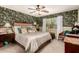 Cozy bedroom featuring designer wallpaper, plush carpeting, and a ceiling fan at 6031 N Milano Ct, Litchfield Park, AZ 85340