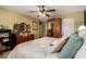 Bright bedroom featuring hard wood furniture, patterned wallpaper, and ceiling fan at 6031 N Milano Ct, Litchfield Park, AZ 85340