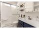 Clean, bright bathroom with a vanity, shower, shelving and a window for natural light at 6156 W Del Rio St, Chandler, AZ 85226