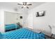 Bright bedroom with a ceiling fan, closet with sliding mirror doors and a wall-mounted TV at 6156 W Del Rio St, Chandler, AZ 85226