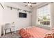Sunlit bedroom featuring a window, floating shelves, modern desk, chair and laminate flooring at 6156 W Del Rio St, Chandler, AZ 85226