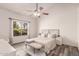 Bright bedroom featuring wood floors, a neutral color palette, and ample natural light at 6156 W Del Rio St, Chandler, AZ 85226