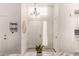 Bright foyer featuring a chandelier, fresh plant, and a clean, inviting entryway with storage hooks at 6156 W Del Rio St, Chandler, AZ 85226