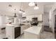 Bright kitchen boasts white cabinets, granite countertops, stainless appliances, and a stylish backsplash at 6156 W Del Rio St, Chandler, AZ 85226