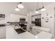 Updated kitchen boasts stainless steel appliances, white cabinets, and a convenient breakfast bar at 6156 W Del Rio St, Chandler, AZ 85226