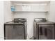 The well-lit laundry room features modern, stainless steel washer and dryer at 6156 W Del Rio St, Chandler, AZ 85226