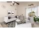Bright living room features neutral colors, a patterned rug, a ceiling fan, and large window at 6156 W Del Rio St, Chandler, AZ 85226
