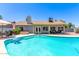 The private backyard has a pool, hot tub, BBQ, lounge chairs, covered patio and green landscaping at 6156 W Del Rio St, Chandler, AZ 85226