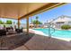 Inviting backyard featuring a sparkling pool, covered patio, and ample seating for outdoor relaxation and entertaining at 6156 W Del Rio St, Chandler, AZ 85226