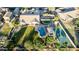 Aerial view showcasing an estate with a swimming pool, tennis court, and mature trees at 6286 S Reseda St, Gilbert, AZ 85298