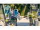 Aerial view highlights a luxurious property with a pool, sport court, and expansive green lawn at 6286 S Reseda St, Gilbert, AZ 85298