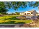 Sprawling backyard with a custom pool, manicured lawn, and spacious patio area at 6286 S Reseda St, Gilbert, AZ 85298