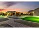 This backyard offers an outdoor kitchen, a golf putting green, and ample room to play at 6286 S Reseda St, Gilbert, AZ 85298