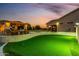 Well-equipped backyard with a covered outdoor kitchen and a putting green for golfers at 6286 S Reseda St, Gilbert, AZ 85298