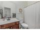 Cozy bathroom with white walls, tile flooring, vanity with wood cabinets, and shower tub at 6286 S Reseda St, Gilbert, AZ 85298