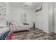 Light-filled bedroom with white walls, wood floors, a double closet, and a decorative shelf at 6286 S Reseda St, Gilbert, AZ 85298
