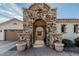 Charming front courtyard with stone accents, wrought iron gate, and a desert landscape at 6286 S Reseda St, Gilbert, AZ 85298