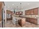 Gourmet kitchen boasts stainless steel appliances, granite counters, and custom cabinets for a luxurious cooking experience at 6286 S Reseda St, Gilbert, AZ 85298