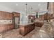 Gourmet kitchen boasts stainless steel appliances, granite counters, and custom cabinets for a luxurious cooking experience at 6286 S Reseda St, Gilbert, AZ 85298