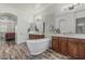 Luxurious main bathroom with a soaking tub, dual vanities, and elegant finishes for ultimate relaxation at 6286 S Reseda St, Gilbert, AZ 85298