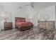 Serene main bedroom with hardwood floors, plantation shutters and stylish furniture at 6286 S Reseda St, Gilbert, AZ 85298