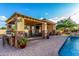 This outdoor kitchen features a TV, a bar, and space for outdoor dining at 6286 S Reseda St, Gilbert, AZ 85298