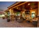Lavish outdoor living space features a fireplace, seating, and bar for upscale entertaining at 6286 S Reseda St, Gilbert, AZ 85298