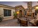 Outdoor patio with a fireplace, seating, and views of the desert landscape at 6286 S Reseda St, Gilbert, AZ 85298