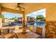 Luxurious covered patio with stone columns, dining area, and pool view, perfect for outdoor entertaining at 6286 S Reseda St, Gilbert, AZ 85298