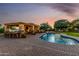 An inviting kidney-shaped pool and custom outdoor living pavilion, perfect for relaxation and entertainment at 6286 S Reseda St, Gilbert, AZ 85298