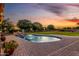 Inviting kidney-shaped pool with a lush yard, perfect for relaxation and summer enjoyment at 6286 S Reseda St, Gilbert, AZ 85298