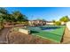 Outdoor tennis court with hardscape area on a well-maintained property at 6286 S Reseda St, Gilbert, AZ 85298