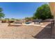 Spacious backyard with pool and rock waterfall feature and shaded lounging area at 634 W Aviary Way, Gilbert, AZ 85233