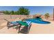 Resort style pool with rock waterfall feature and plenty of space to lounge around the pool at 634 W Aviary Way, Gilbert, AZ 85233