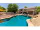 Inviting backyard pool with built-in waterfall, lounging area, and a covered patio, perfect for entertaining at 634 W Aviary Way, Gilbert, AZ 85233