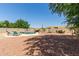 Expansive backyard featuring a shimmering pool with rock waterfall, lounge chairs, and shaded outdoor dining area at 634 W Aviary Way, Gilbert, AZ 85233