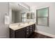Bathroom featuring a dual sink vanity, large mirror, and ample lighting creates a bright and functional space at 634 W Aviary Way, Gilbert, AZ 85233