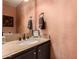 Stylish powder room features a granite countertop, vessel sink, and decorative mirror creating a welcoming space at 634 W Aviary Way, Gilbert, AZ 85233
