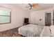 A spacious bedroom is complete with a ceiling fan, closet access, and a large window at 634 W Aviary Way, Gilbert, AZ 85233