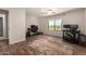 Bright bedroom with a view is complete with wood-look flooring, two desks, and ceiling fan at 634 W Aviary Way, Gilbert, AZ 85233