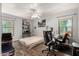 Well-lit bedroom featuring a workspace with desk, rolling chairs, and a ceiling fan at 634 W Aviary Way, Gilbert, AZ 85233