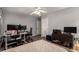 A cozy bedroom featuring a dedicated workspace, a television, and wood-look flooring at 634 W Aviary Way, Gilbert, AZ 85233