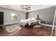 Calming main bedroom with a neutral color palette, plush rugs, a ceiling fan, and outdoor views at 634 W Aviary Way, Gilbert, AZ 85233