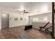 Versatile bonus room with wood floors, a ceiling fan, ample natural light, and workout equipment at 634 W Aviary Way, Gilbert, AZ 85233