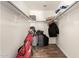 Empty closet with wood-look flooring, rods, and shelving for optimal storage at 634 W Aviary Way, Gilbert, AZ 85233