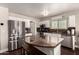 Bright kitchen with stainless appliances, granite countertops, white cabinetry and exposed aggregate flooring at 634 W Aviary Way, Gilbert, AZ 85233